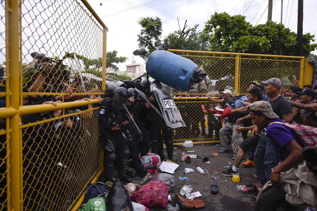 Guatemalan riot police clash with Honduran migrants trying to cross the Guatemala-Mexico international border bridge in Ciudad Tecun Uman, Guatemala, on October 28, 2018.