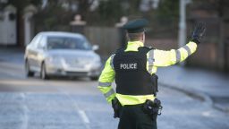 A PSNI Road Policing officer flags down oncoming drivers during a random drink driving checkpoint in Belfast. A drunk mother doing the school run after a boozy lunch was among the hundreds of drivers caught using new police powers to conduct random breath tests in Northern Ireland. (Photo by Liam McBurney/PA Images via Getty Images)
