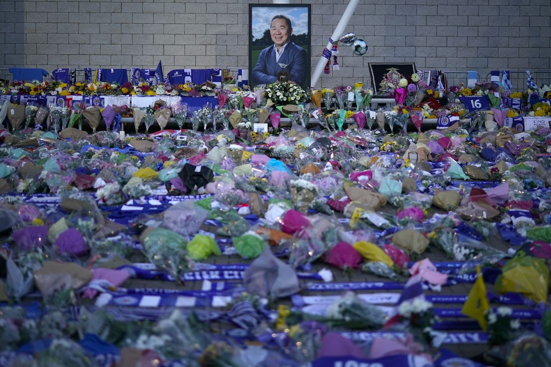 A portrait of Vichai Srivaddhanaprabha surrounded by a sea of tributes