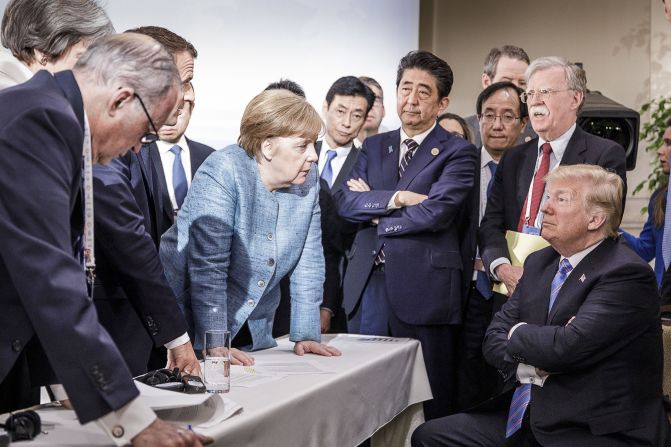 In this photo provided by the German Government Press Office, Merkel talks with Trump as they are surrounded by other leaders at the G7 summit in June 2018. According to two senior diplomatic sources, <a href="index.php?page=&url=https%3A%2F%2Fwww.cnn.com%2F2018%2F06%2F11%2Fpolitics%2Fg7-photo%2Findex.html" target="_blank">the photo was taken</a> when there was a difficult conversation taking place regarding the G7's communique and several issues the United States had leading up to it.