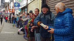 People form human chain to help community bookshop move books
