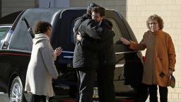Mourners embrace after the hearse carrying the casket of Dr. Jerry Rabinowitz, one of 11 people killed while worshipping at the Tree of Life synagogue on Saturday, arrives outside the Jewish Community Center in Pittsburgh, Tuesday, Oct. 30, 2018. (AP Photo/Gene J. Puskar)