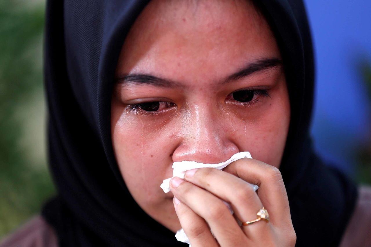 A relative of a passenger cries at a hospital in Jakarta.