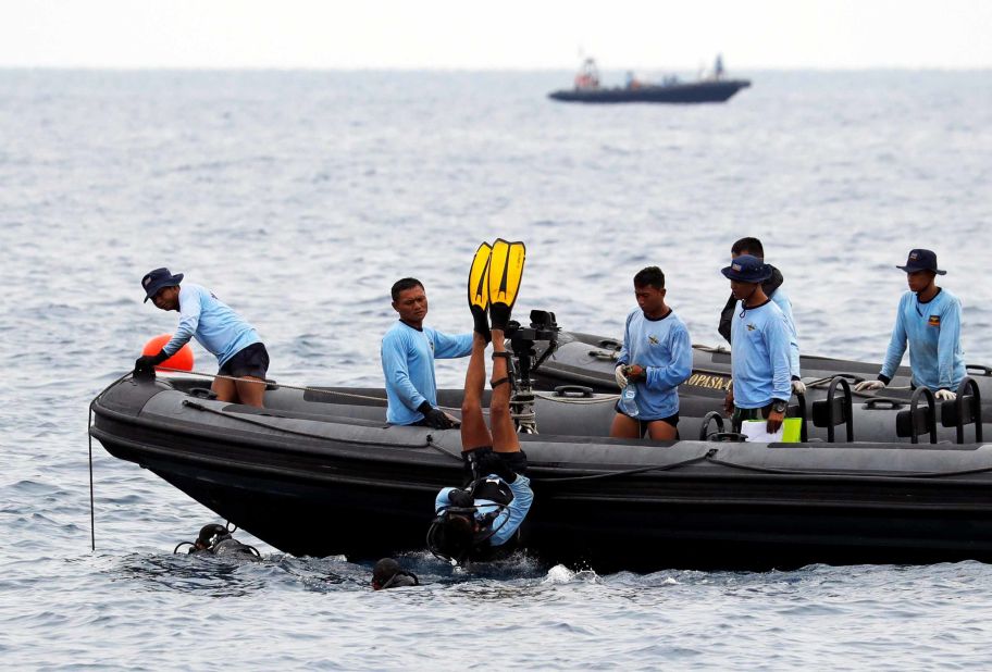 A diver with the Indonesian Navy enters the water off the north coast of Karawang.