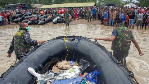 Soldiers push inflatable raft as they carry debris of the Lion Air flight JT610 airplane that crashed into the sea, as they walks onto Tanjung Pakis beach in Karawang, Indonesia.