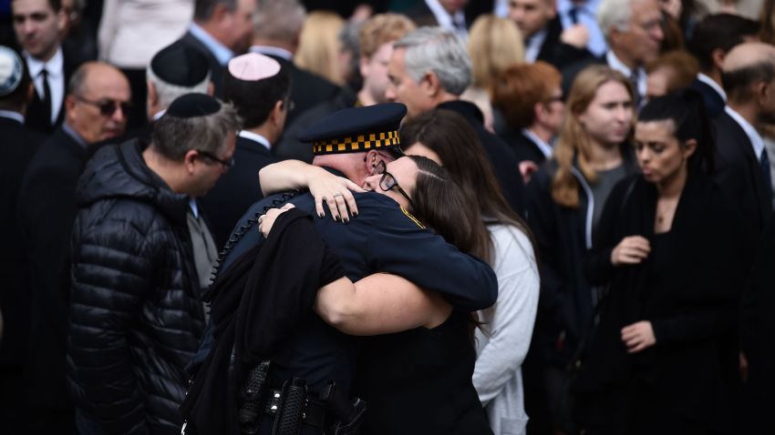 Mourners embrace outside the Rodef Shalom Congregation where the funeral for Tree of Life Congregation mass shooting victims Cecil Rosenthal and David Rosenthal who are brothers will be held October 30, 2018 in Pittsburgh, Pennsylvania. - Much loved brothers Cecil and David Rosenthal, inseparable in life as in death, were treasured members of the Pittsburgh Jewish community, remembered as the sweetest souls and devoted to the synagogue where they were killed. The city on Tuesday bid farewell to the pair, who had developmental disabilites and reportedly lived together, in the first funerals for those killed in the worst anti-Semitic attack in US history. (Photo by Brendan SMIALOWSKI / AFP)        (Photo credit should read BRENDAN SMIALOWSKI/AFP/Getty Images)