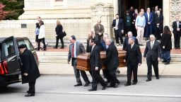 Mourners gather as a casket is carried outside the Rodef Shalom Congregation where the funeral for Tree of Life Congregation mass shooting victims Cecil Rosenthal and David Rosenthal who are brothers will be held October 30, 2018 in Pittsburgh, Pennsylvania. - Much loved brothers Cecil and David Rosenthal, inseparable in life as in death, were treasured members of the Pittsburgh Jewish community, remembered as the sweetest souls and devoted to the synagogue where they were killed. The city on Tuesday bid farewell to the pair, who had developmental disabilites and reportedly lived together, in the first funerals for those killed in the worst anti-Semitic attack in US history. (Photo by Brendan SMIALOWSKI / AFP)        (Photo credit should read BRENDAN SMIALOWSKI/AFP/Getty Images)