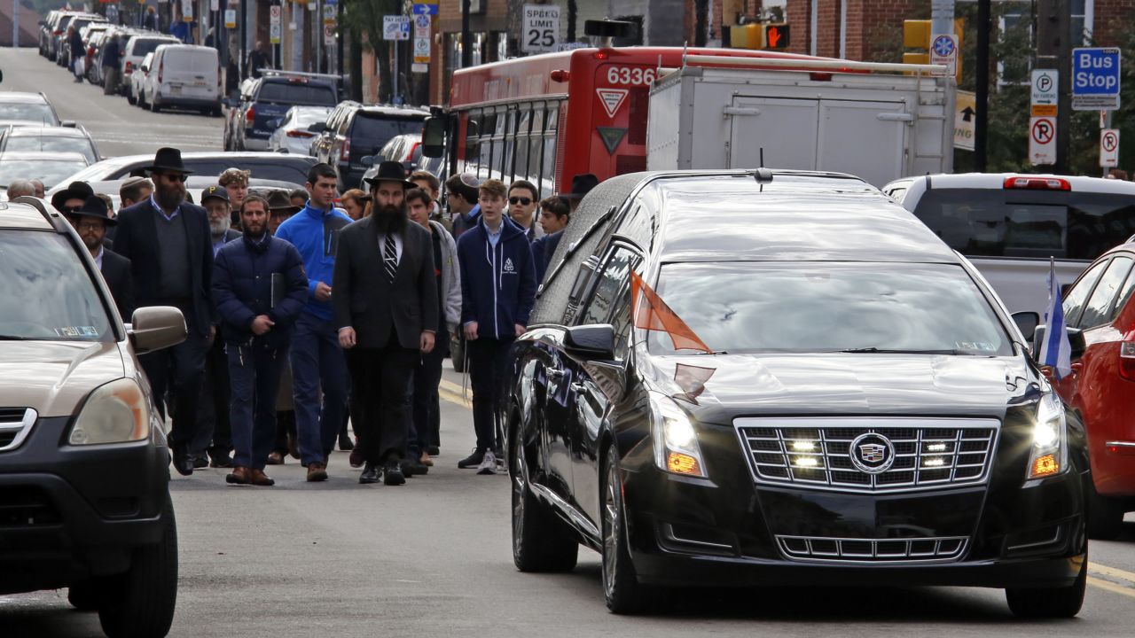 Mourners walk behind the hearse carrying the casket of Dr. Jerry Rabinowitz following a funeral service at the Jewish Community Center in the Squirrel Hill section of Pittsburgh, Tuesday Oct. 30, 2018. Rabinowitz was one of 11 people killed while worshipping at the Tree of Life Synagogue on Saturday Oct. 27, 2018. (AP Photo/Gene J. Puskar)