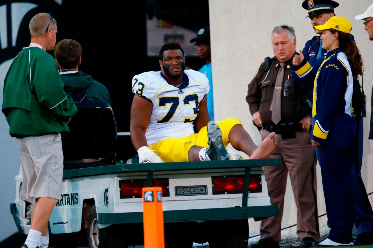 Former Michigan Wolverine Maurice Hurst Jr. is carted off the field during a game against Michigan State in 2014.  "It's a real tough duty being a college football player," he said, crediting the show "All or Nothing: The Michigan Wolverines" for an accurate portrayal of student-athletes. 