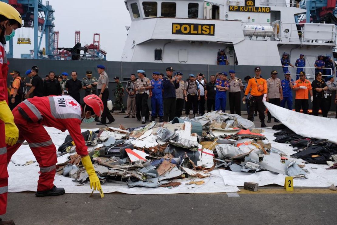 Search teams examine debris pulled from the sea near the crash site of Lion Air flight 610.