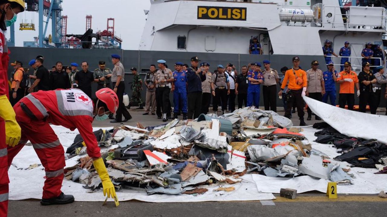 Search teams examine debris pulled from the sea near the crash site of Lion Air flight 610.