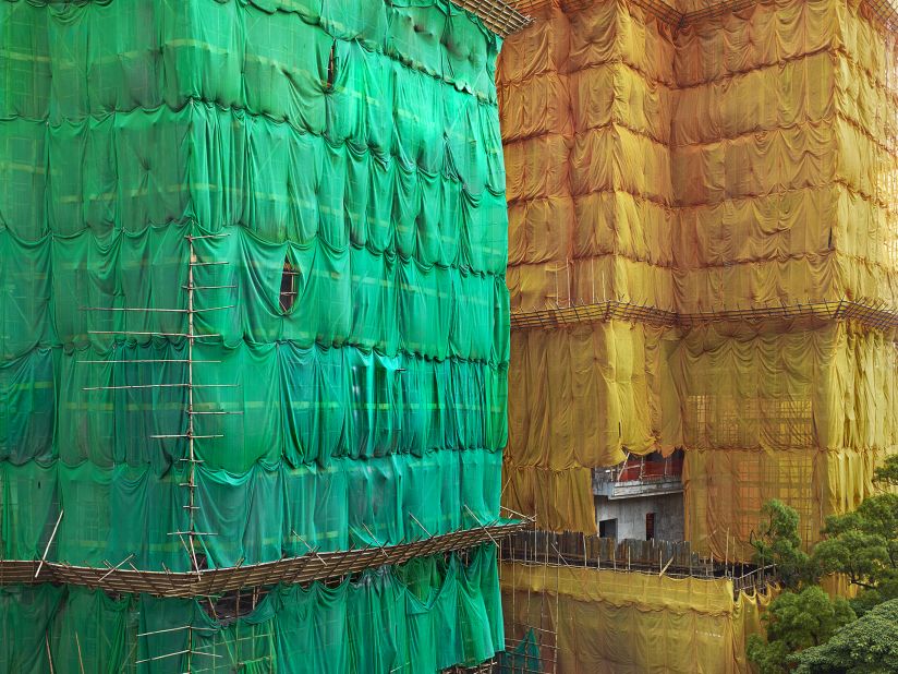 A close-up shot shows the nylon sheets supported by bamboo scaffolding.