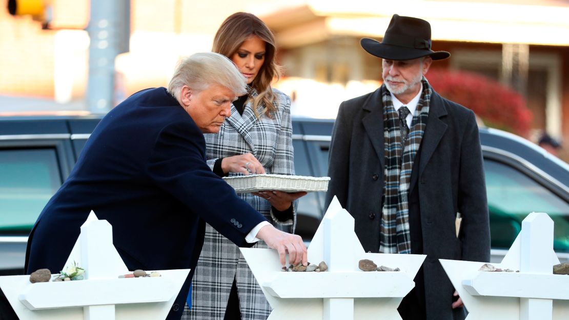 The President and first lady put down stones from the White House and flowers at a memorial for those killed in the massacre.
