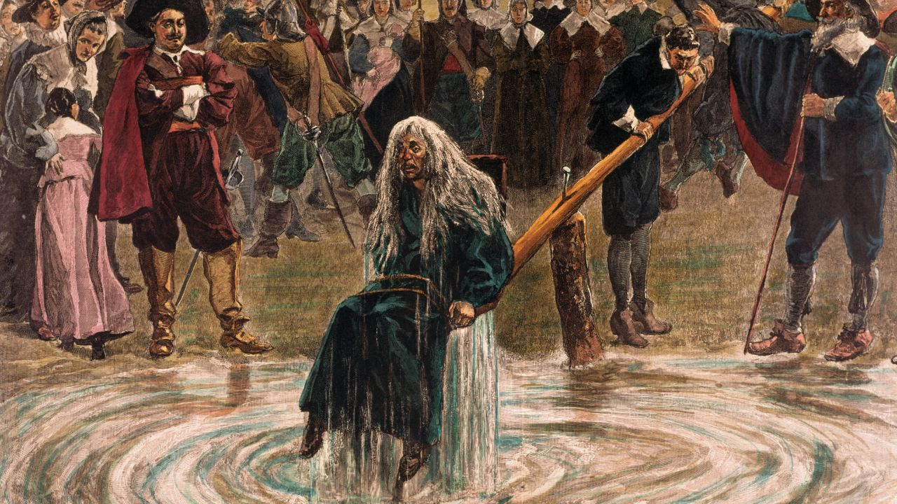 An accused witch going through the judgment trial, where she is dunked in water to prove her guilt of practicing witchcraft.