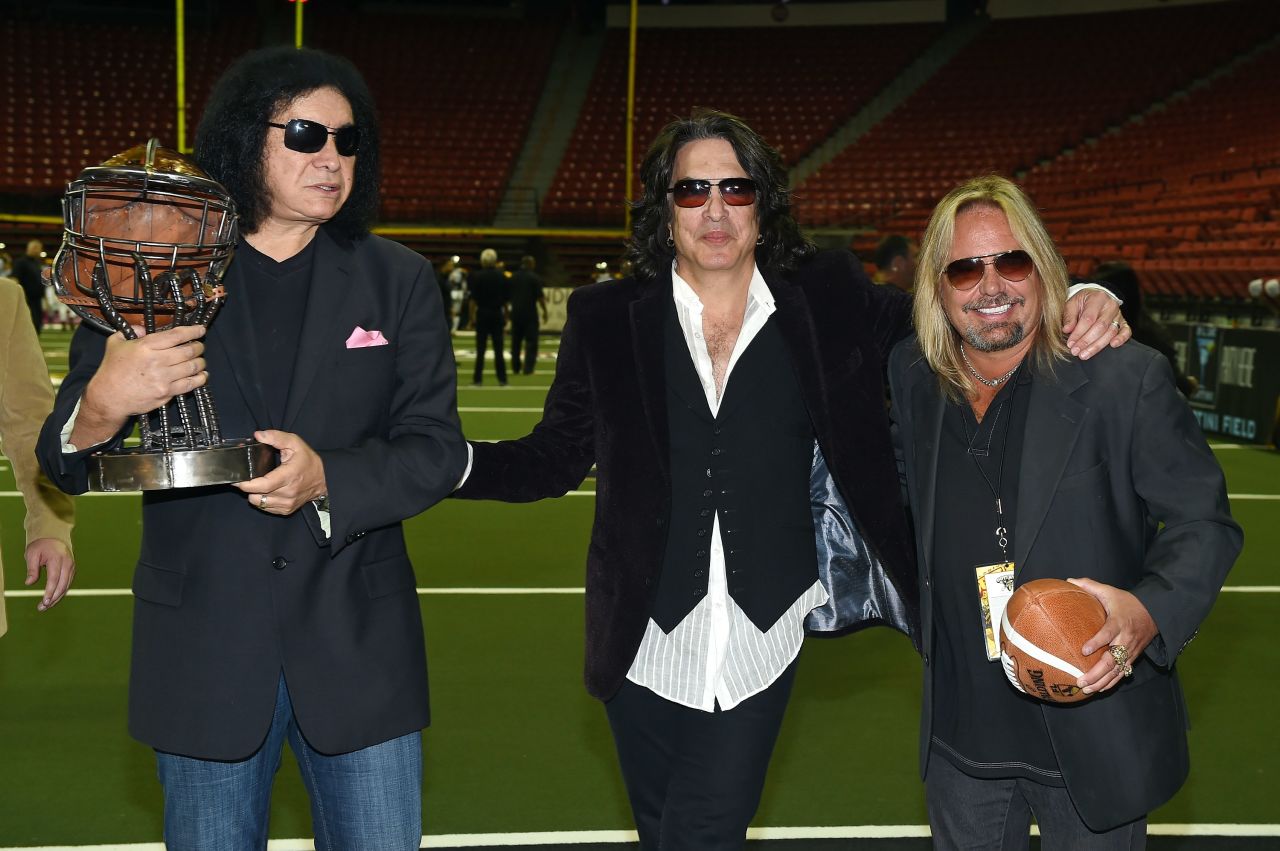 Owners of the Los Angeles Kiss, Gene Simmons (left) and Paul Stanley (middle), pose alongside Motley Crue singer Vince Neil, owner of the Las Vegas Outlaws, before squaring off in Las Vegas on May 4, 2015. The TV series "4th and Loud" depicted the travails of football ownership during the Kiss's first season. 