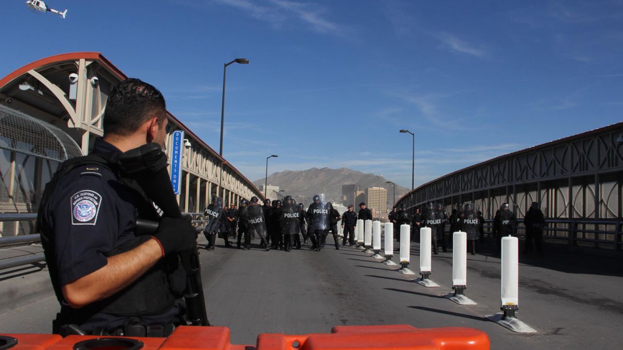 US customs and border patrol agents and riot policemen take part in a border security drill at the US-Mexico international bridge, as seen from Ciudad Juarez, Mexico, on October 29, 2018. - Dozens of migrants get to the border crossing linking El Paso, Texas and Ciudad Juarez, Chihuahua state, every day, ahead of a caravan of Central Americans seeking political asylum in the United States. (Photo by Herika Martinez / AFP)        (Photo credit should read HERIKA MARTINEZ/AFP/Getty Images)