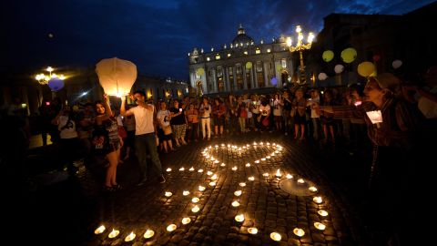 Demonstrators stand by candles shaping a heart and the number 30 as they coomemorate the 30th anniversary of Emanuela Orlandi disappearance in Saint Peter's Square at the Vatican on June 22, 2013