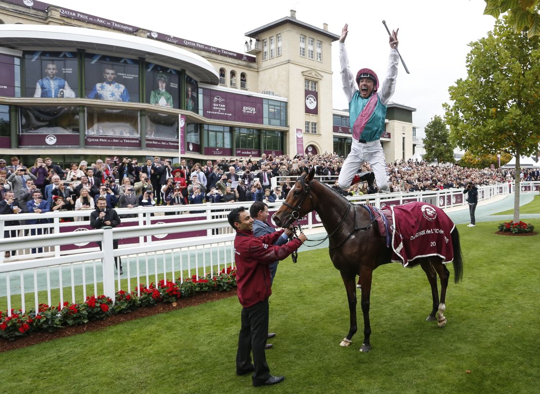 Frankie Dettori performs his trademark flying dismount after Enable won her first Arc in 2017.