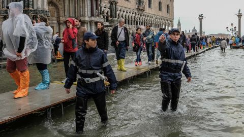 Local police start to clear people from St. Mark's Square on Monday because of the flooding.