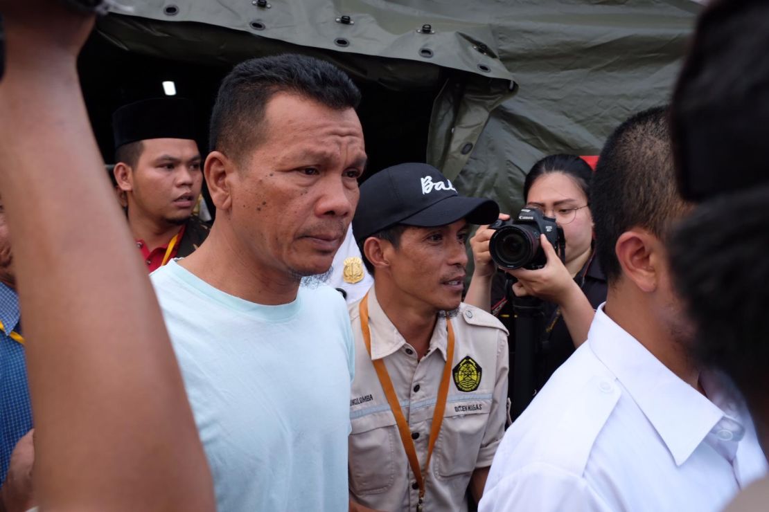 Epi Syamsul Qomar arrives at the port to see if any of the personal effects retried from the sea belong to his 24-year-old son.