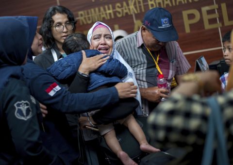 A relative of a passenger cries at a Jakarta hospital on Tuesday, October 30. Family members have been providing authorities with DNA samples to help identify victims of the crash.