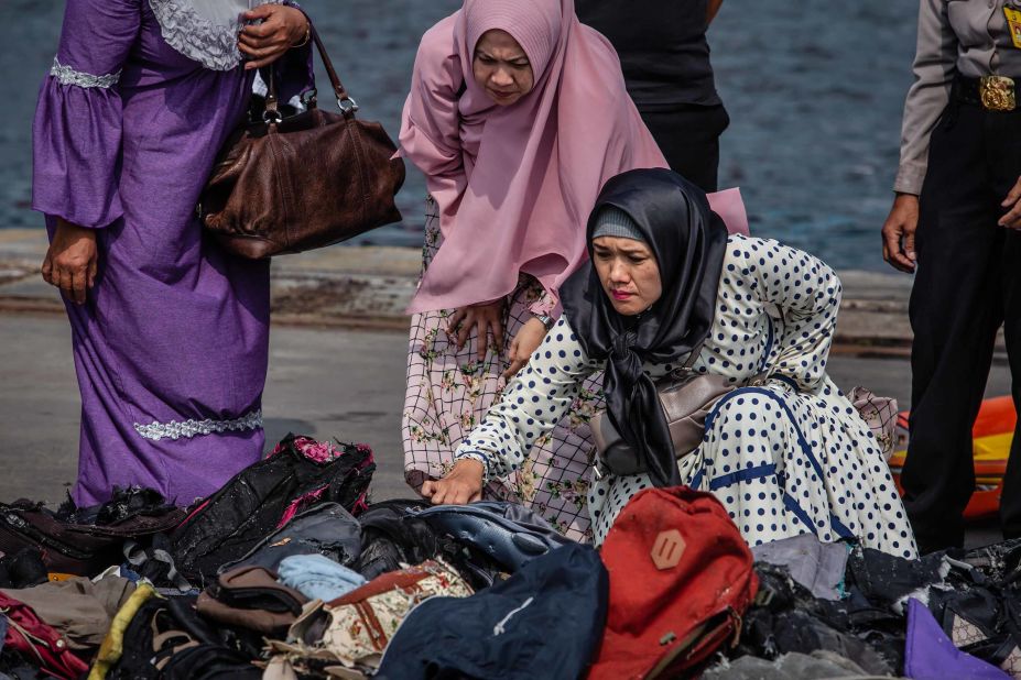 Families of the victims look through personal items that were recovered from the wreckage.