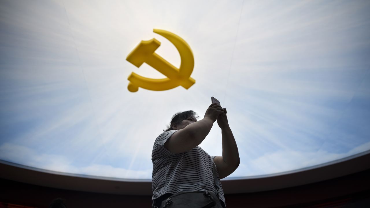 A woman uses her mobile phone to take a picture during a visit to the Chinese Military Museum in Beijing on September 8, 2017. / AFP PHOTO / WANG Zhao        (Photo credit should read WANG ZHAO/AFP/Getty Images)