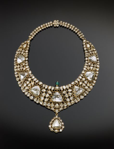 Martin Chapman calls this necklace "a tour de force of Indian princely jewelry," designed to express the power and wealth of its owner. The piece's eight large diamonds, each weighing between 10 to 15 carats, are modified brilliant cuts. The cuts represent an advance in gem-faceting technology in India. The symmetrical arrangement of the gems and the central pendant reveal Western influences. 