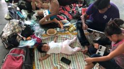 A baby sleeps among thousands of migrants at the old bus station in Juchitán, Mexico, which local volunteers prepared to house the migrant caravan.