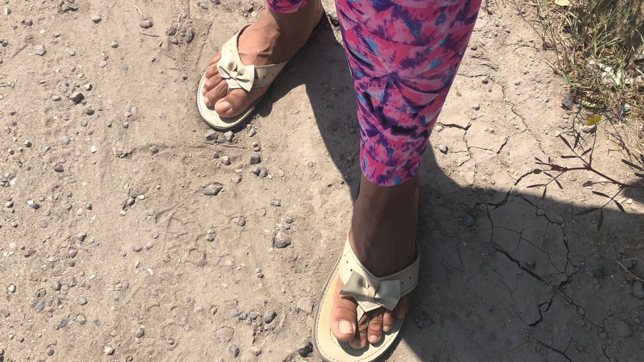Lillian from Tegucigalpa, Honduras, is traveling with her son Tiago, 1, and she has worn flip flops, often the only shoes migrants can afford.