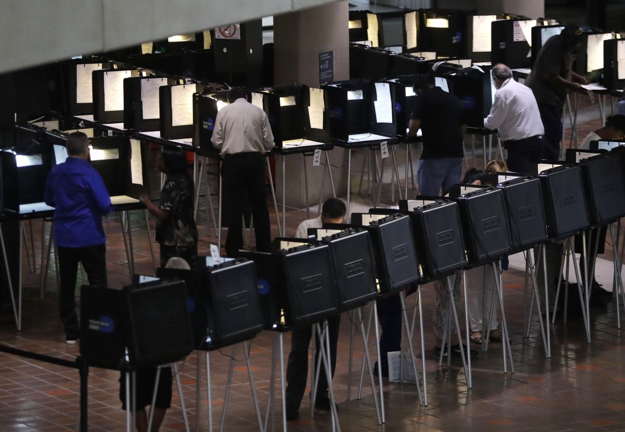 People vote in Miami on October 22.