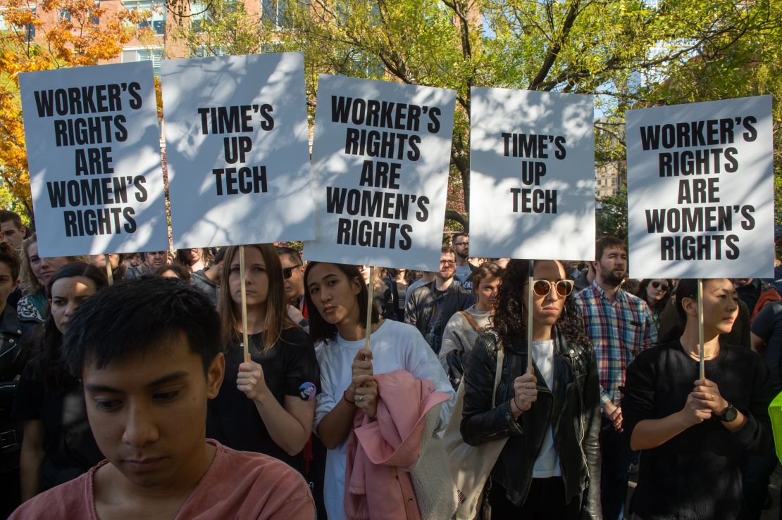 In New York, employees held signs calling for new policies on handling harassment allegations.