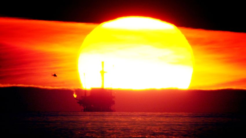 The sun sets behind the Hillhouse A oil and gas platform near the Federal Ecological Reserve in the Santa Barbara Channel, February 15, 2001, near Santa Barbara, CA.