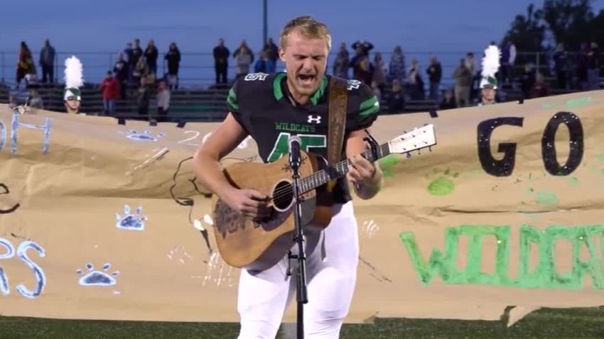 football player sings national anthem 1