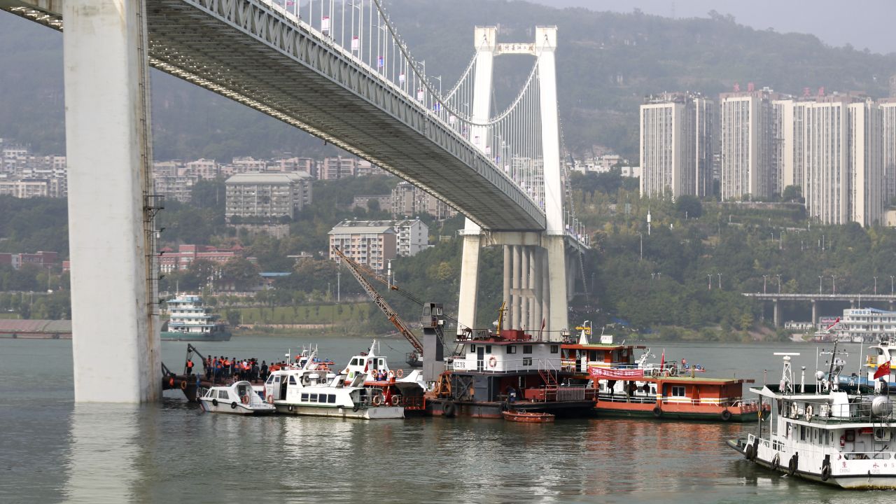 Rescuers conduct search and rescue operation at the site where a bus has plunged off a bridge into the Yangtze River in Wanzhou on October 28.