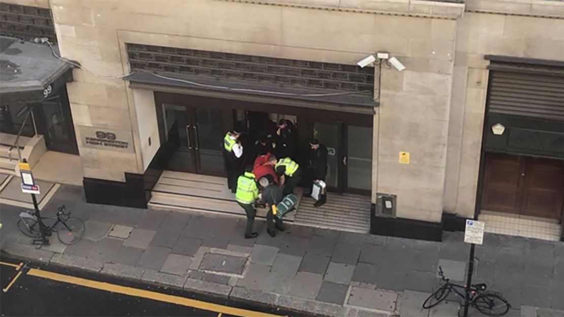 A person is carried out of a building on a stretcher in Derry Street, Kensington, on Friday.