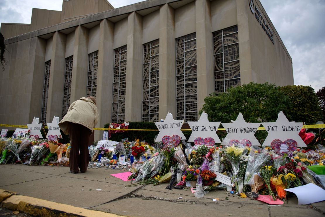 Mourners play tribute after 11 people were killed in a 2018 mass shooting at the Tree of Life Congregation in Pittsburgh. The capital murder trial for the alleged killer is scheduled to begin in April, but the governor has said he will sign a reprieve for every execution warrant sent to his desk.