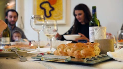 Myriam's family sit down together for Shabbat dinner in a Parisian suburb.