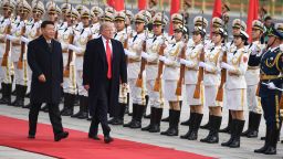 China's President Xi Jinping (L) and US President Donald Trump review Chinese honour guards during a welcome ceremony at the Great Hall of the People in Beijing on November 9, 2017. / AFP PHOTO / JIM WATSON        (Photo credit should read JIM WATSON/AFP/Getty Images)