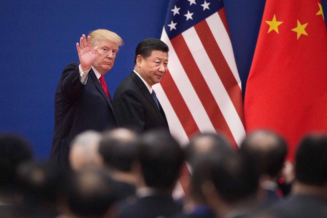 US President Donald Trump (L) and China's President Xi Jinping leave a business leaders event at the Great Hall of the People in Beijing on November 9, 2017.