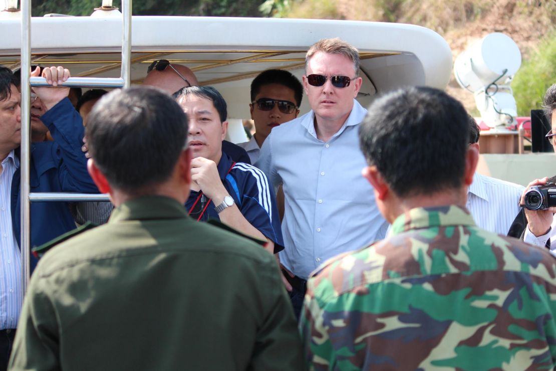 Jeremy Douglas of the UNODC (center) is seen on a Chinese patrol boat on the Mekong River between Myanmar and Laos in 2016.