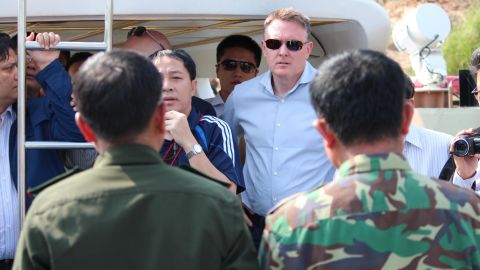 Jeremy Douglas of the UNODC (center) is seen on a Chinese patrol boat on the Mekong River between Myanmar and Laos in 2016.