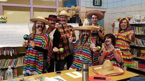 Another now-deleted picture from the school's Facebook page showed staff members dressed in sombreros with maracas.