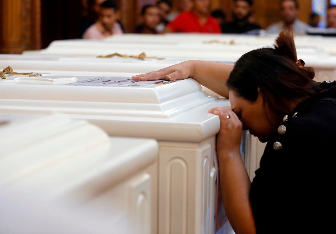 A relative grieves during the funeral service Saturday in Minya.
