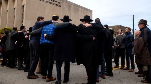 Members of the Jewish faith gather outside the Tree of Life synagogue Friday evening for Shabbat services.