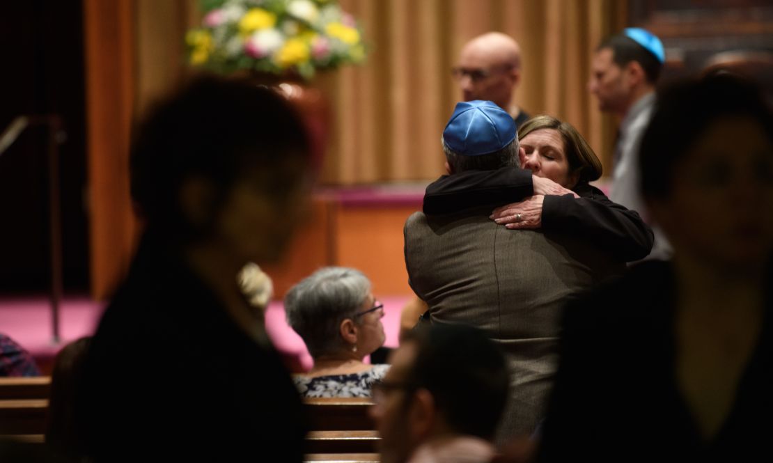 People of faith greet each other at Temple Sinai before Friday evening Shabbat services. 