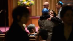 People greet each other in the sanctuary at Temple Sinai before Friday evening Shabbat services. Temple Sinai opened it doors to Pittsburgh-area Jews and people of all faiths. 
