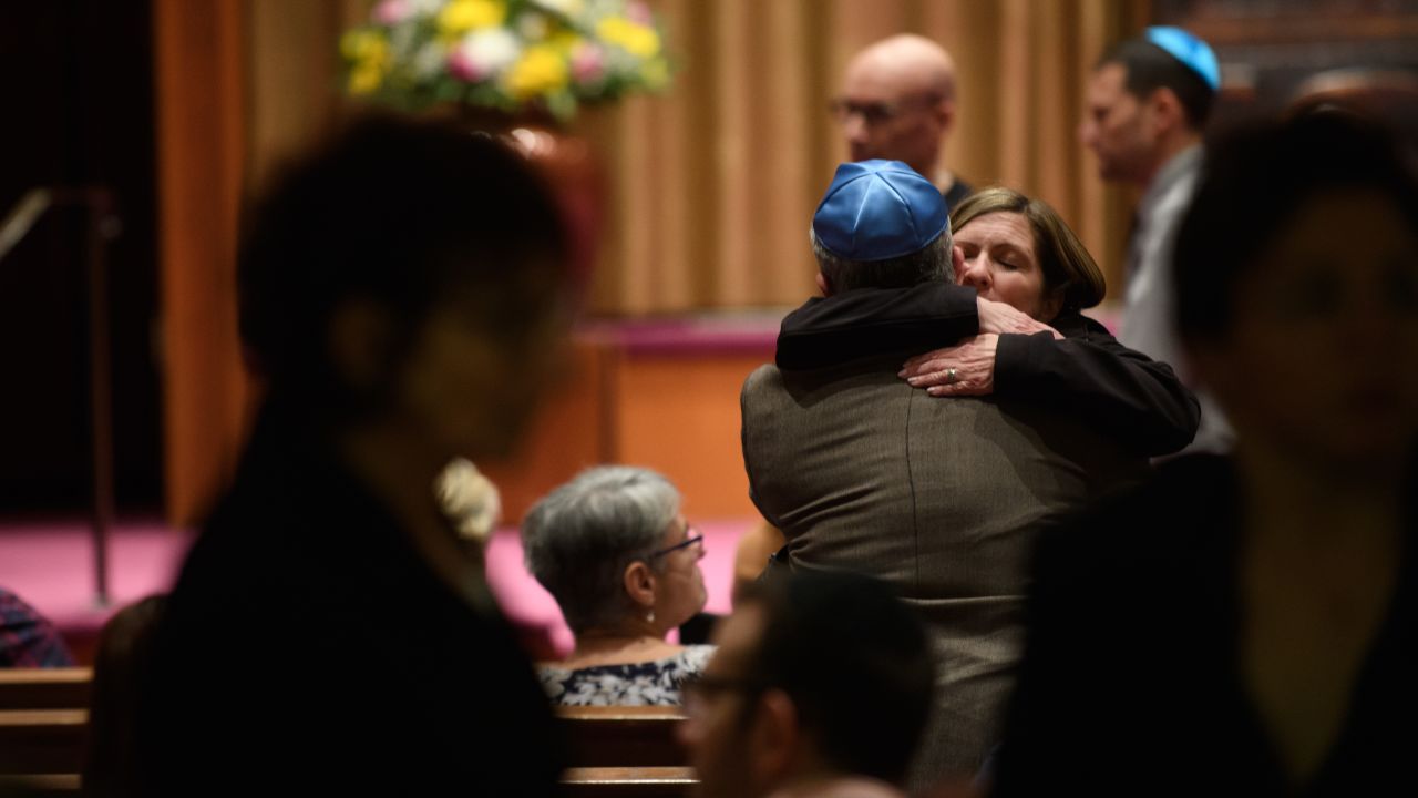 People of faith greet each other in the sanctuary at Temple Sinai before Friday evening Shabbat services. Temple Sinai opened its doors to Pittsburgh-area Jews and people of all faiths. 