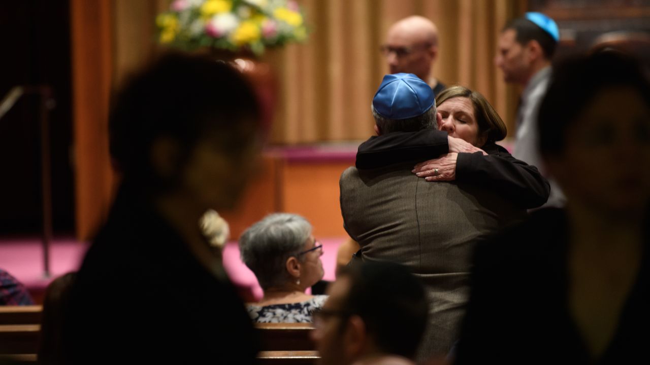 People of faith greet each other at Temple Sinai before Friday evening Shabbat services.