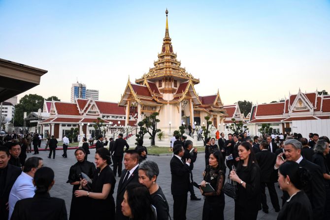 Mourners arrive at the Wat Thepsirin temple for Srivaddhanaprabha's funeral. He and four others died in a wreck a week earlier, just moments after departing the Leicester City's pitch.